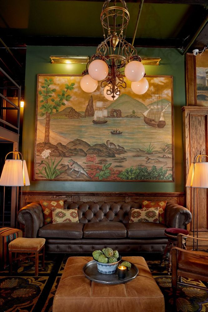 Styled against hand-painted walls, this Arhaus chair is chosen for elegance that supports the flow of conversation