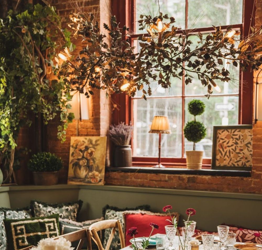 Cozy window nook in Maxwell’s Garden Room, with lush Cox London decor.