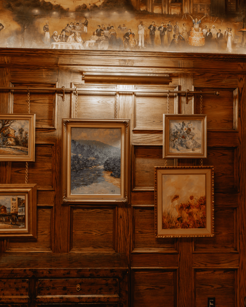 Picture rails in brushed brass add a gallery-level finish to Maxwell's wood-clad walls