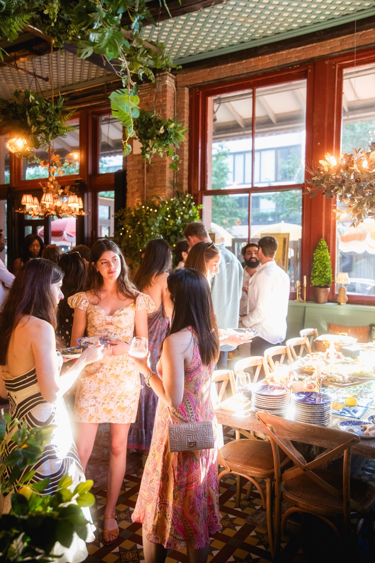 A bright, daytime gathering where natural light, fresh florals, and a full buffet invite unhurried connection.