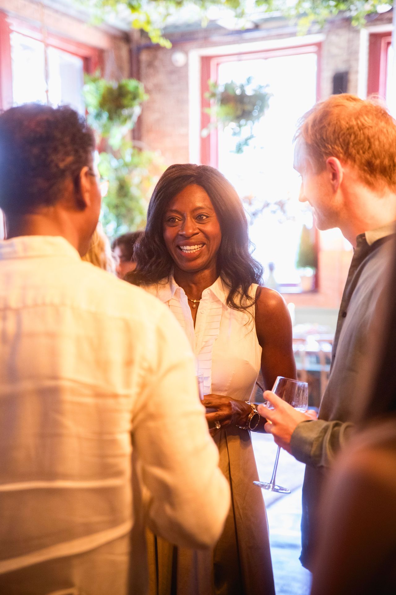 Guests in lively conversation, glasses in hand — the evening’s warmth reflected in every smile