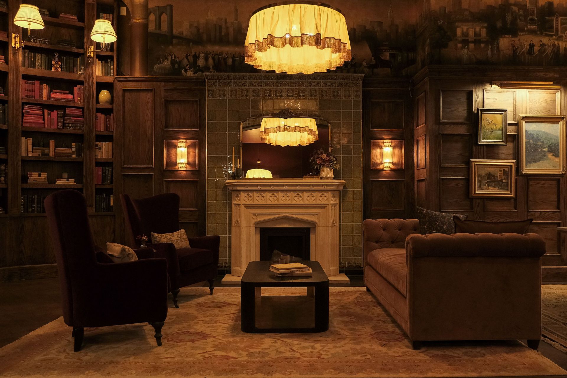 Centered above the fireplace, the chandelier becomes part of the architecture, balancing warmth, scale, and detail