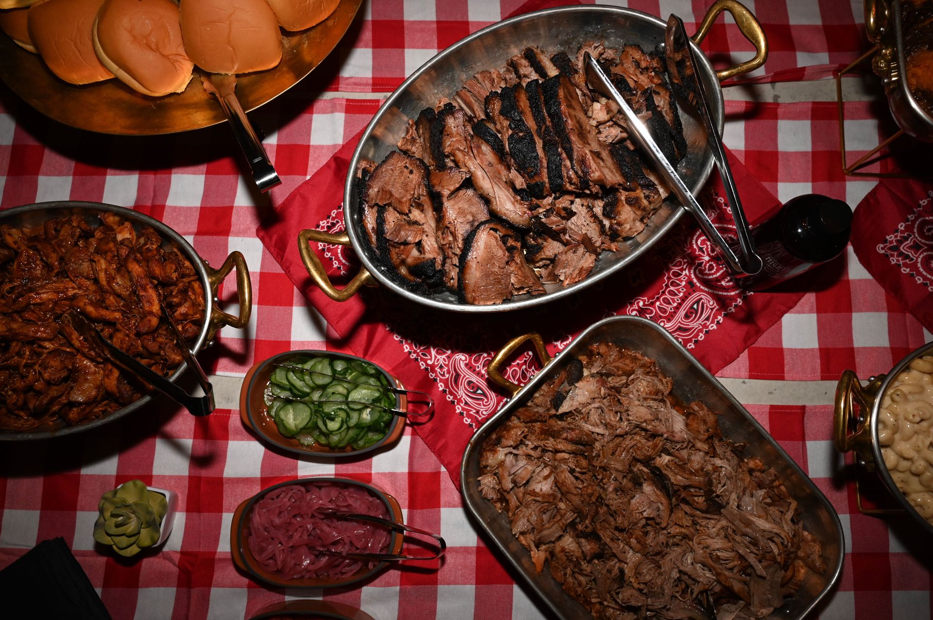 Texas barbecue filled the table — brisket, pulled pork, buns, and sides, all laid out