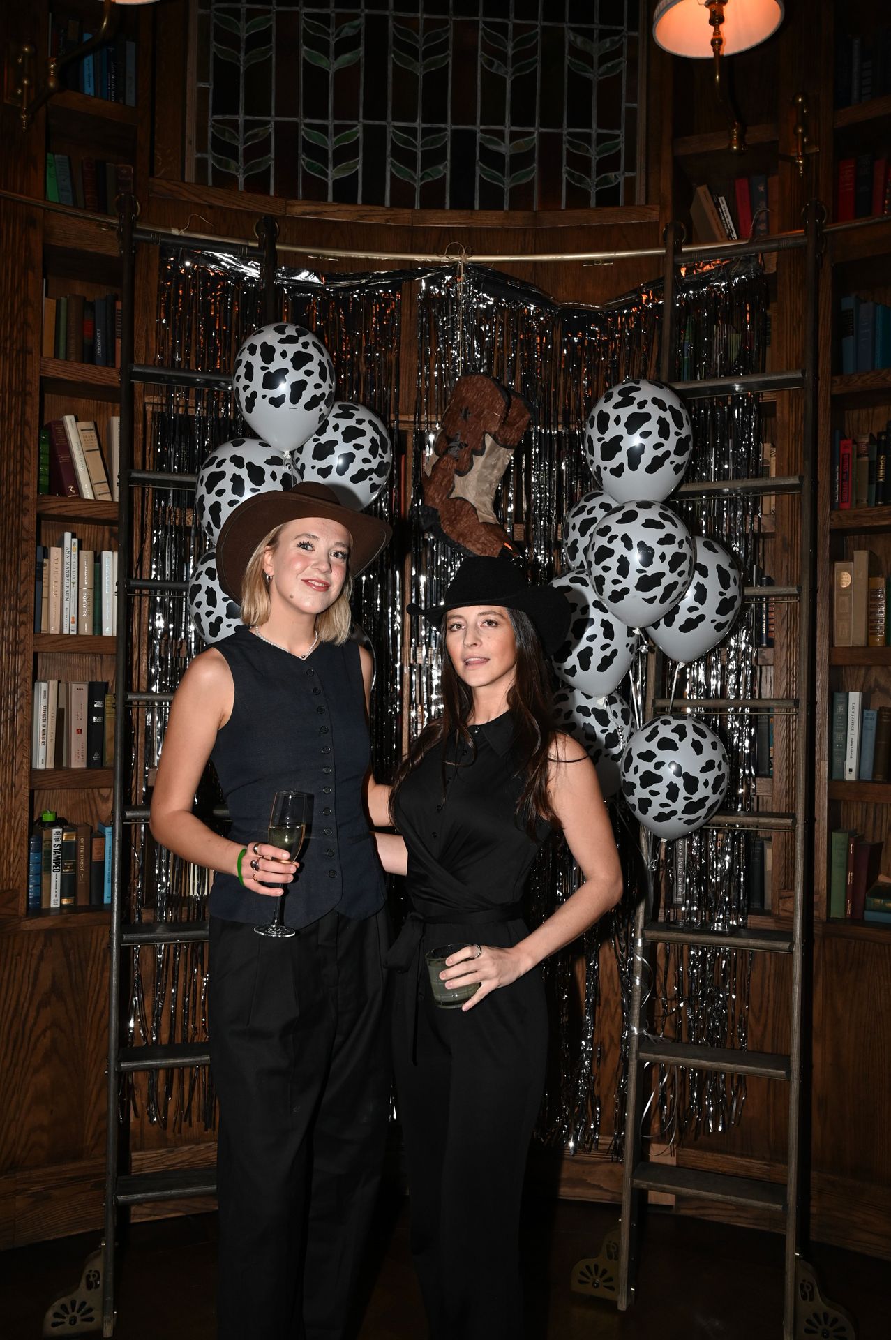 Hats on, glasses in hand, and cow-print balloons to set the scene