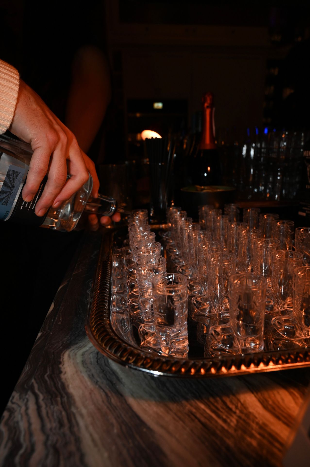 Behind the bar, rounds of tequila filled the waiting cowboy-boot glasses
