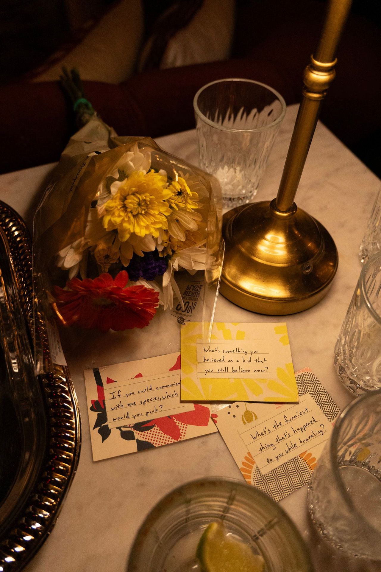 Details that matter — flowers and conversation cards sparking connections at the table.