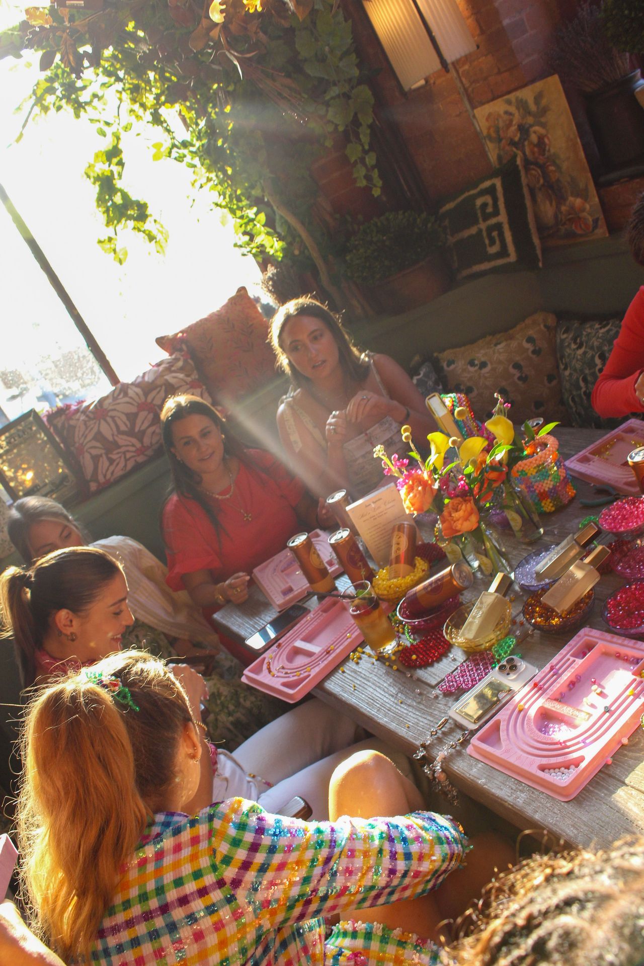 Guests surrounded by vibrant florals and the sparkle of Betty Booze