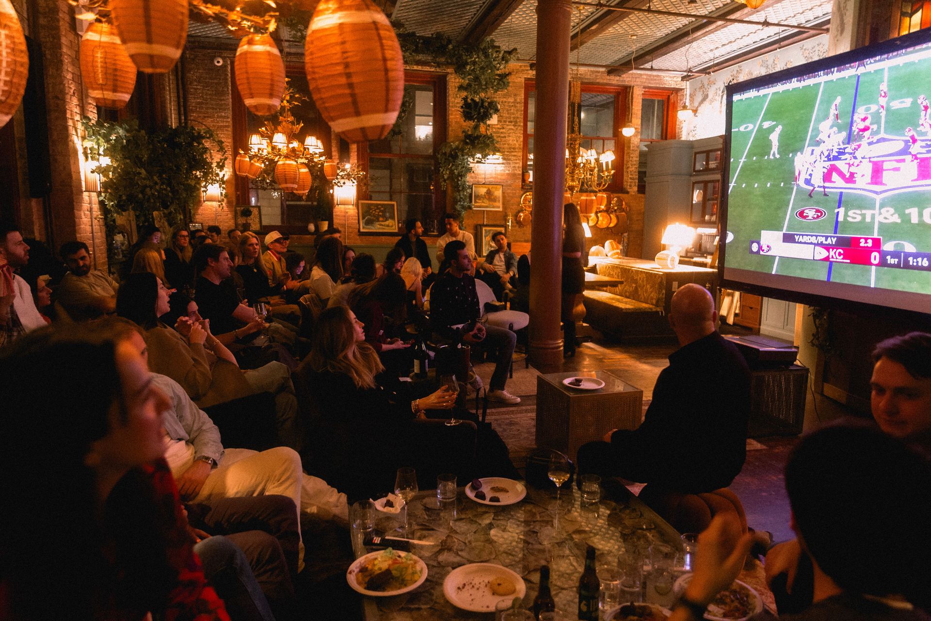 Footballs lit in a warm golden glow, adding a playful, game-day twist to Maxwell’s classic interiors