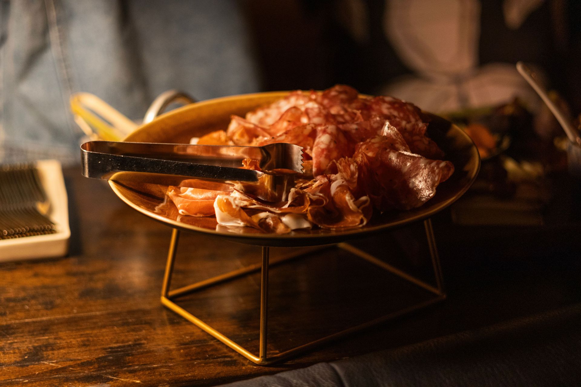 A beautifully presented selection featuring an array of cured meats and accompaniments