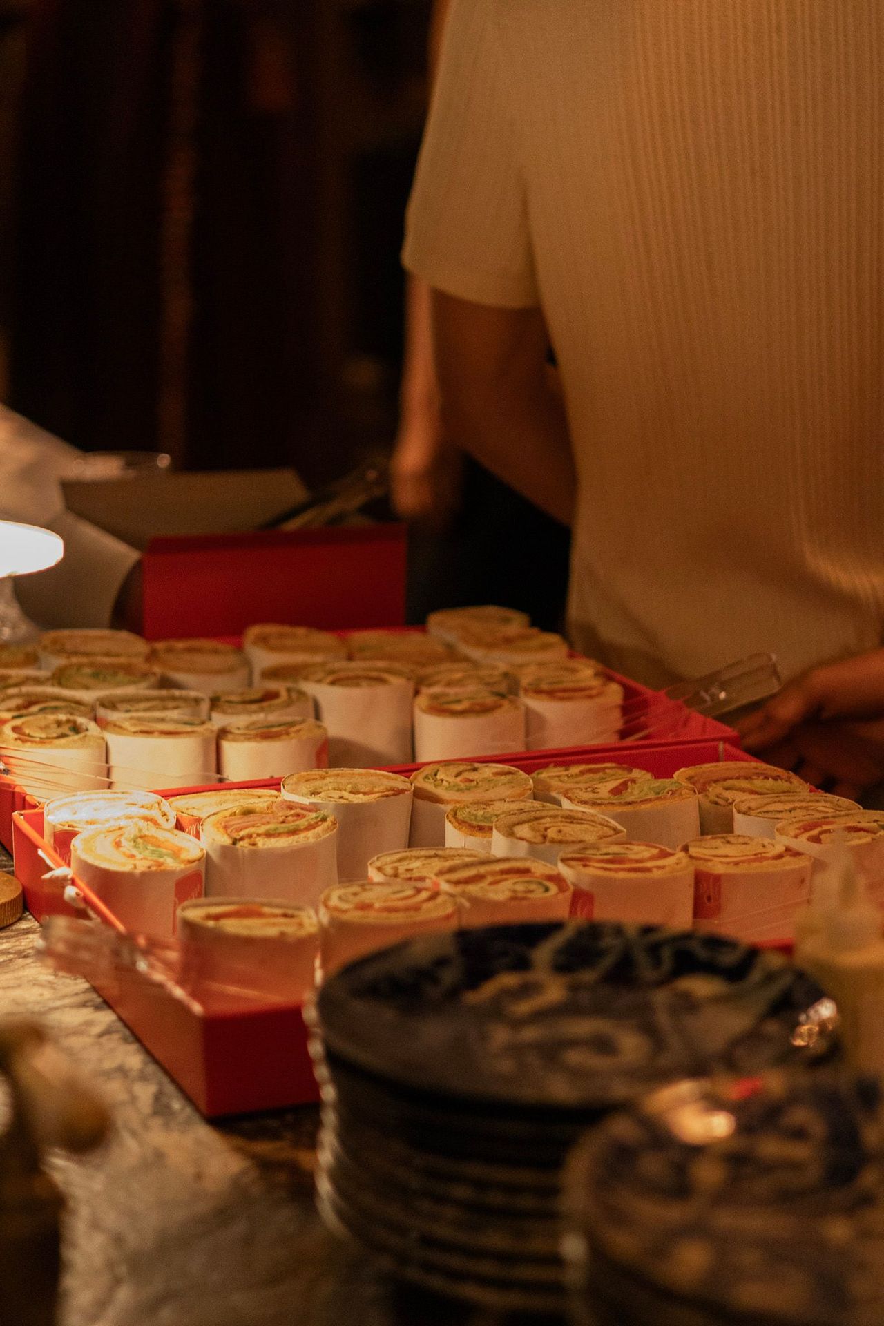 Party fuel — trays of colorful wraps ready for guests to grab.