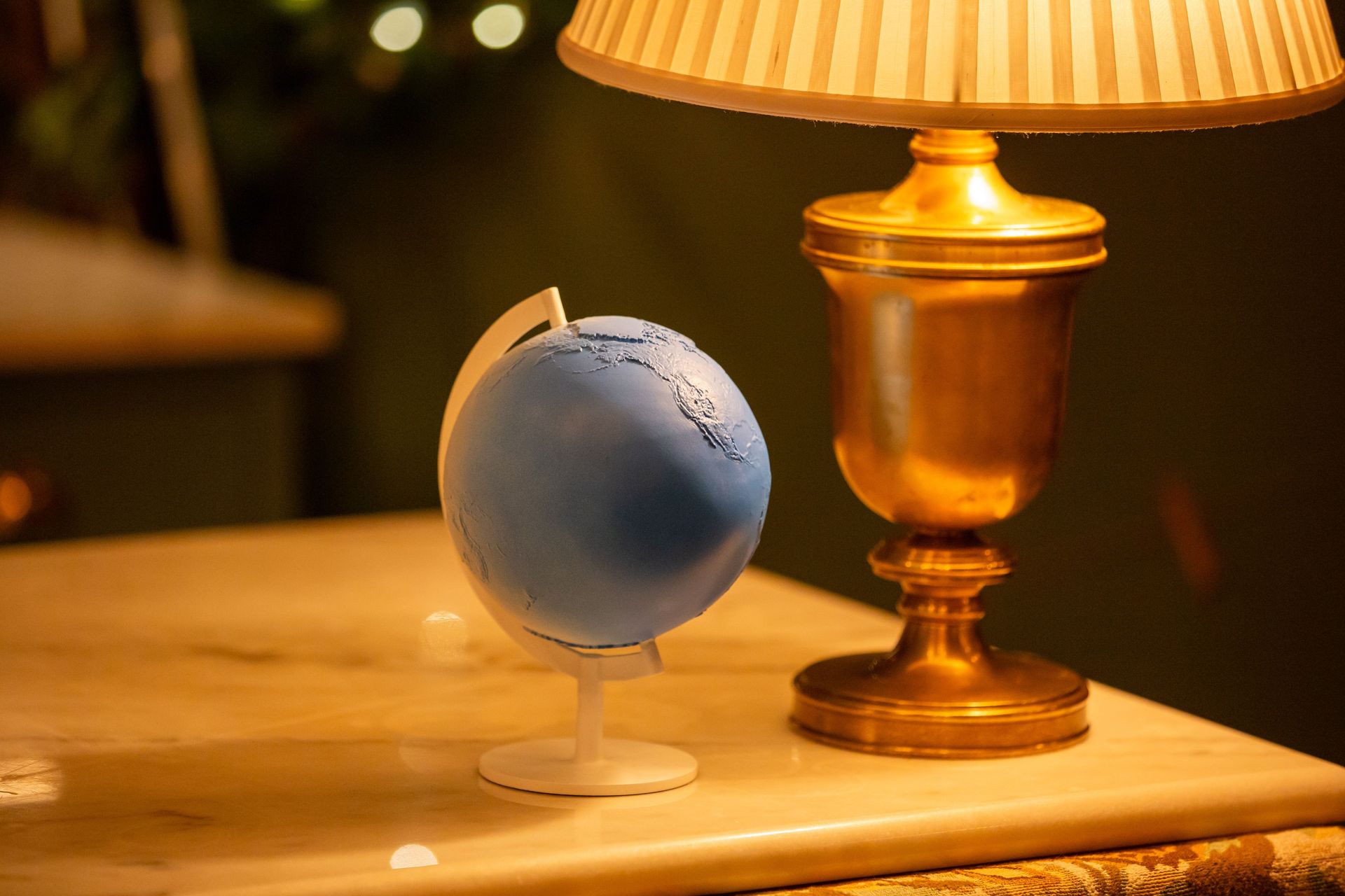 A close-up of the distinctive blue globe trophy presented to Matt Damon by the Elevate Prize