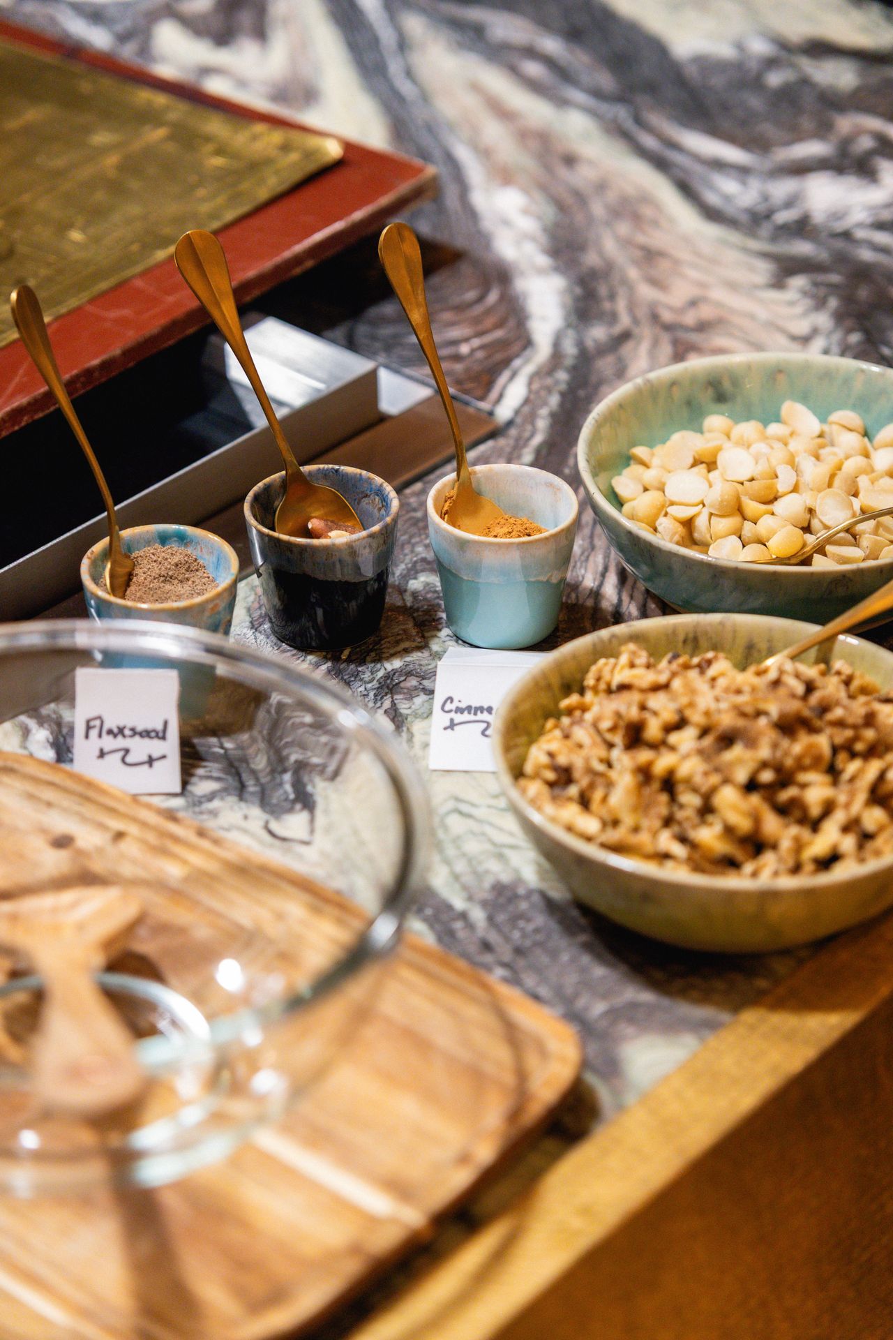 Bowls of nuts, seeds, and spices lined up like a lab bench, ready for Blueprint experimentation