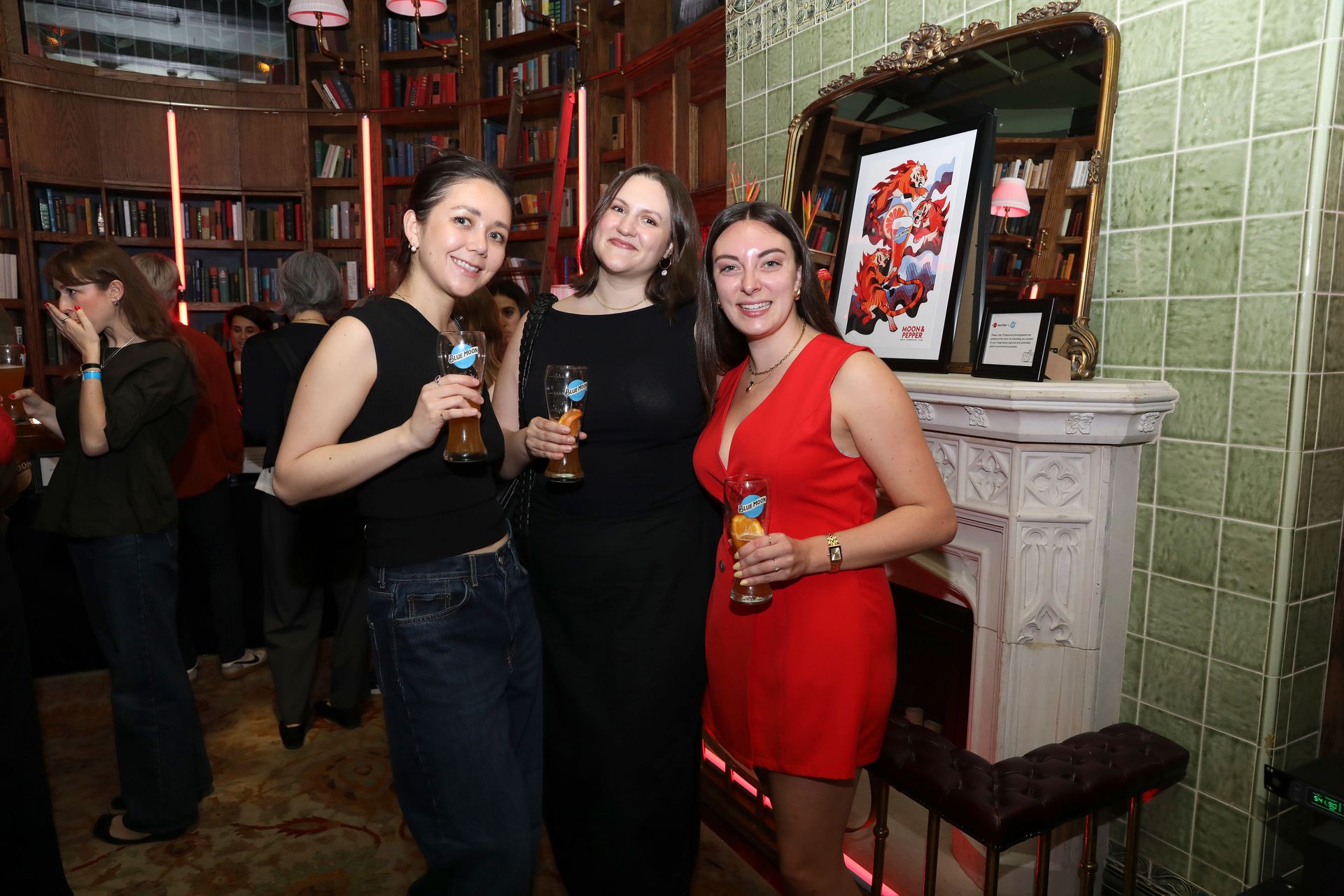 Smiles all around as guests hold cocktails and good company in Maxwell library lounge